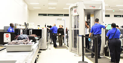 Airport security checkpoint, symbolizing immigration screening | Serving Immigrants, Inc.