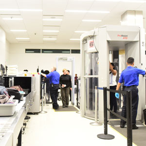 Airport security checkpoint, symbolizing immigration screening | Serving Immigrants, Inc.